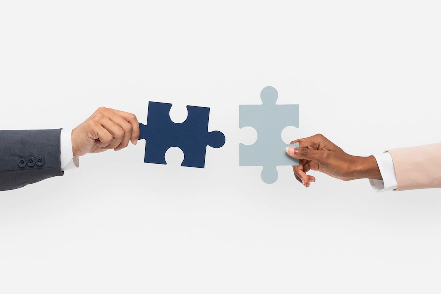 Honesty is the key Hands of two people try to join piece of puzzle showing recruitment firm and candidate