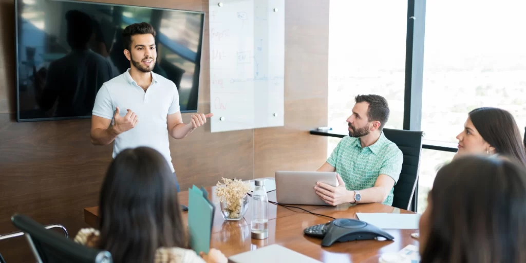 A man giving presentation in conference room showcasing his communication skill sets